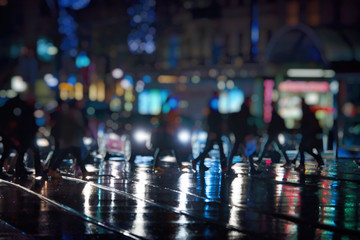 pedestrians walking on rainy night in the city