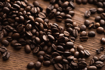 fresh roasted coffee beans scattered on wooden table