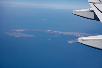Fototapeta na wymiar Panoramic view of the Greek islands, Cyclades from the window of an airliner.