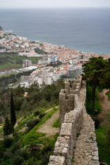 Fototapeta premium Beautiful aerial view of Sesimbra, Portugal - focus on defensive castle walls