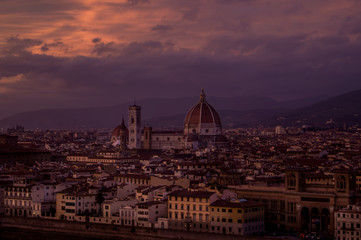 Fototapeta na wymiar An intense red and purple sunset over florence