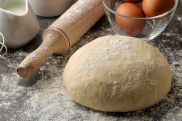 Dough for baking. making delicious cookies. Ingredients for the dough, eggs, flour, butter, sugar on a dark background