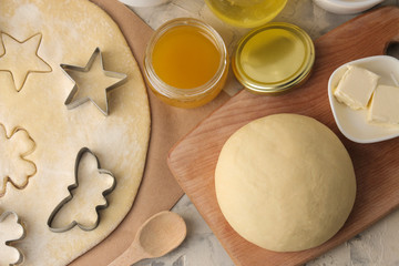 making delicious cookies. Cookie cutters. Dough for baking. Ingredients for the dough, eggs, flour,...