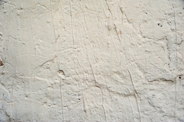 Abstract background. White pre-putty on the wall with irregularities. Structure, background.