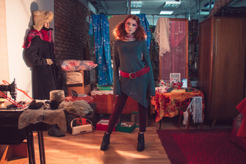 Beautiful curly red-haired girl in the Soviet room.