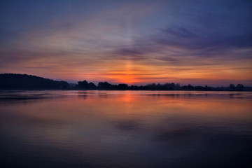 Sun pillar over the Vistula river in northern Poland, just before the sunrise.