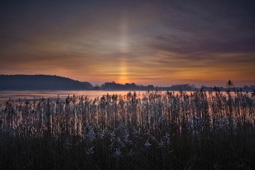 Sun pillar over the Vistula river in northern Poland, just before the sunrise. © jholy