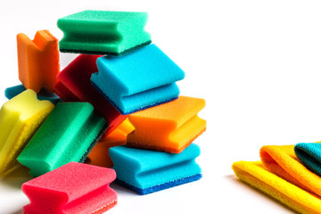 Dish washing sponges on a white background. A pile of sponges and rags, gloves for washing dishes on a white background.