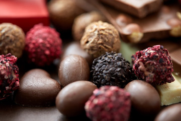 sweets, confectionery and food concept - close up of different chocolate candies