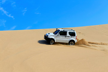 Fototapeta na wymiar An suv was driving through the desert