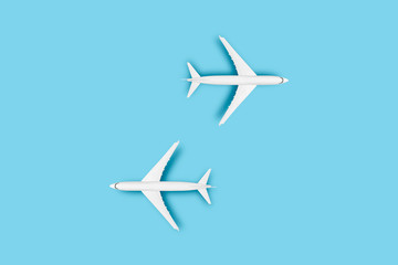 Two Airplanes on a blue background. Concept travel, airline tickets, flight, pallet route, transfer. Banner. Flat lay, top view