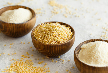 Hulled millet flour and grain in bowls