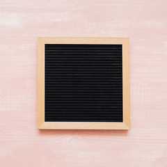 blackboard on pink wooden background