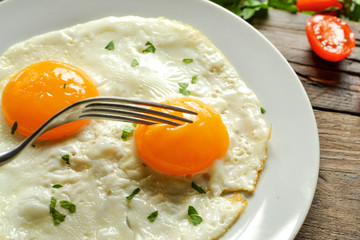 Fried eggs in a plate. Yolk close-up. Tasty breakfast. Appetizing egg breakfast