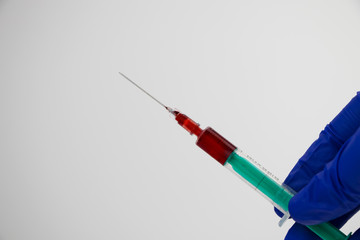 Syringe and test tube close up. The doctor does a blood sampling. Laboratory where blood tests are...