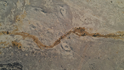 Aerial top down view of Negev desert, Ezuz village. Sandy land surface from above. Beautiful patterns on earth. Texture, background. Israel.