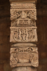 Fototapeta na wymiar Hand carved columns in mughal temple, Qutub Minar, Delhi, India