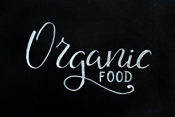 Black chalkboard with an ORGANIC FOOD hand lettering