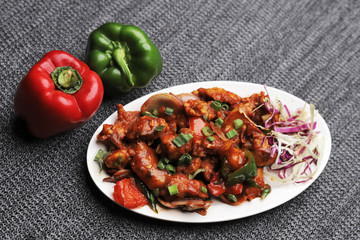 Dragon chicken. Chicken strips marinated, fried and sautéed in a spicy and tangy sauce