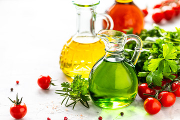 Different types of vegetable oil in glass bottles: sesame, linseed, grape oil. Place for text