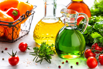 Different types of vegetable oil in glass bottles: sesame, linseed, grape oil.