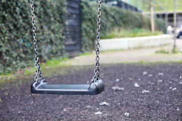 Empty swing with chains on the playground