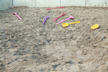Big child's sandpit with shovels and rakes