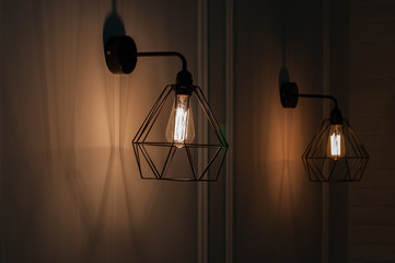 Lamp on a black background. Pendant lights made of diamond shape wire carcass with glass bulb...
