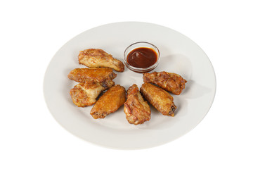 Hot appetizer chicken pieces, legs, wings, fried in oil, tomato sauce, ketchup, B-B-Q, before alcohol, on plate, white isolated background, Side view. For the menu, restaurant, bar cafe