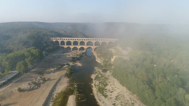 Drone shot of Pont du Gard and Gardon's canyon in the morning. An amazing bridge, aqueduct built in first century by romans. 