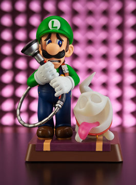 Moscow, Russia - February 25, 2020: Luigi and Ghost Polterpup figurine on pink background