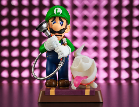 Moscow, Russia - February 25, 2020: Luigi and Ghost Polterpup figurine on pink background