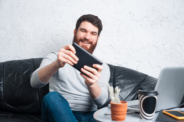 happy man playing games at tablet 