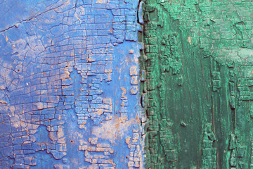 Old wooden background with remains of pieces of scraps of old paint on wood. Texture of an old tree, vintage wood background peeling paint. old blue board with cracked paint