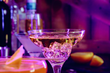 Cocktail drinks with ice in club lights
