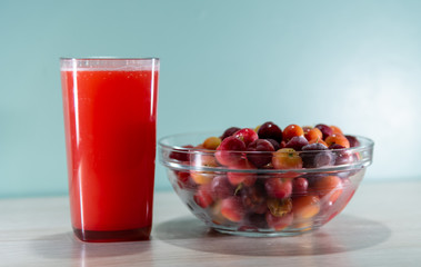 Fresh fruits and acerola juice on a wooden surface