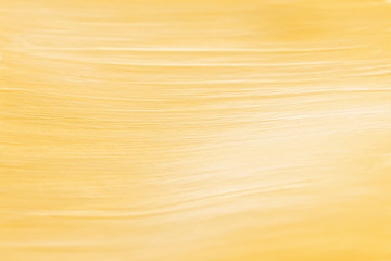 Closeup side view of gold paint brush strokes with shallow depth of field. Abstract modern trendy...