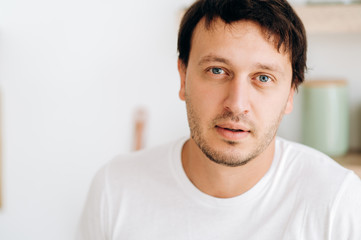 Portrait of a handsome blue-eyed guy in a white T-shirt