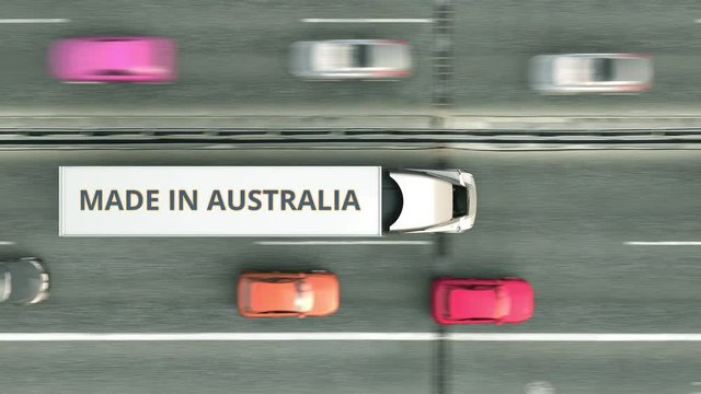 Trailer trucks with MADE IN AUSTRALIA text driving along the highway. Australian business related loopable 3D animation