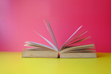 Close up of open book on color background 