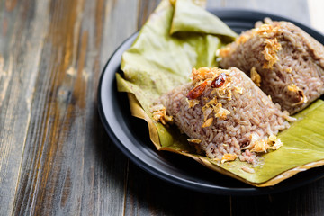 Traditional Northern Thai food (Khao Kan Chin), steamed pudding with rice, rice mixed with pork blood and steamed inside banana leaf