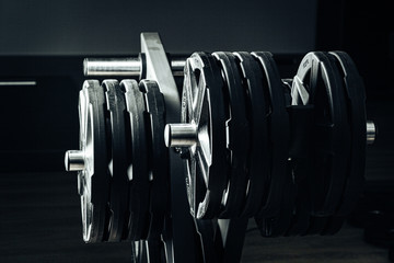 Gym weight plates on holder close up