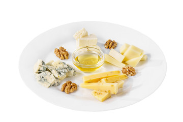 Snack to wine, sweet, a set of cheeses, honey, Walnut, aperitif before alcohol, food on plate, white isolated background Side view. For the menu, restaurant, bar, cafe