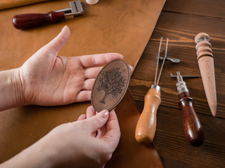 Genuine Leather. Sewing a purse. Leather work. Tools for sewing bags, wallets, clutches. Stitching....
