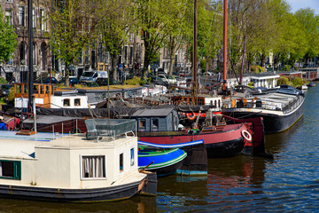 Fototapeta na wymiar Buildings and boats along the canal in Amsterdam, Netherlands