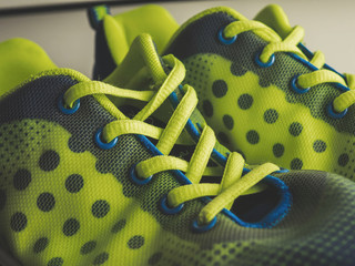 lacing on green sneakers close-up