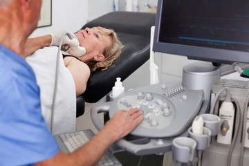 Casual patient undergoing examination thyroid
