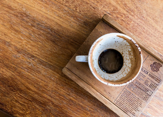 Empty coffee cup and a wooden tray