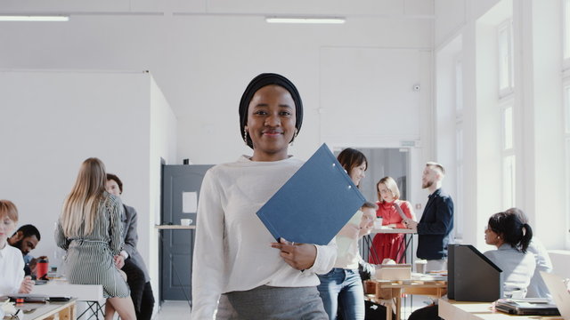 Happy Successful African Female Manager In Head Scarf Walking At Modern Office Smiling At Camera Slow Motion RED EPIC.