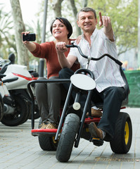 Fototapeta na wymiar couple driving double bike
